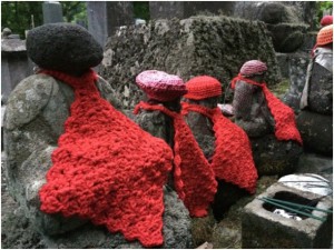 sculptures with knitted hats and bibs or scarves