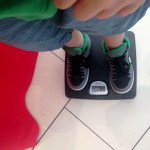 Child's feet on a scale to determine body weight