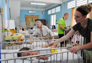 OT student visits with infant in orphanage
