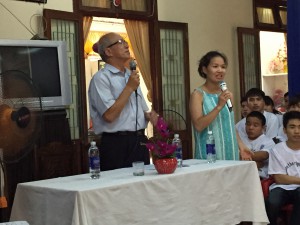 2 Vietnamese workers welcoming the group at a vocational training center