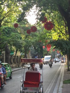 street scene in Hanoi - rickshaw & colorfuk flowers