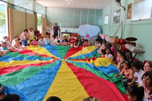 Children & adults with a multi-colored parachute